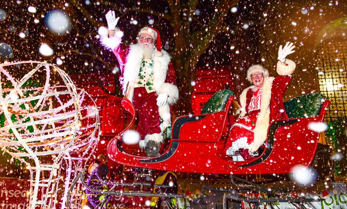 Santa and Mrs Claus on their sleigh, taking part in the Swansea Christmas Parade